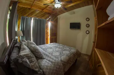 a bedroom with a bed and a ceiling fan at Villas Fernanda #2 in Fortuna