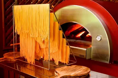 a pile of pasta hanging from a pizza oven at Villas Fernanda #2 in Fortuna
