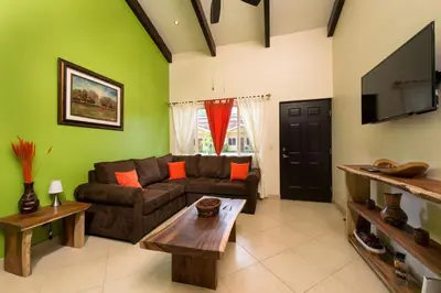 a living room with a couch and a tv at Cabo Velas Estates 30 in Matapalo