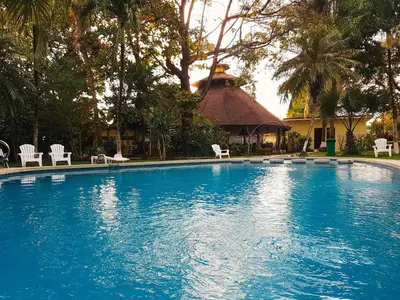 a large swimming pool with chairs and a gazebo at Samara Beach Hotel in Sámara