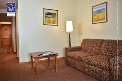a living room with a couch and a table at Sleep Inn Paseo Las Damas in San José
