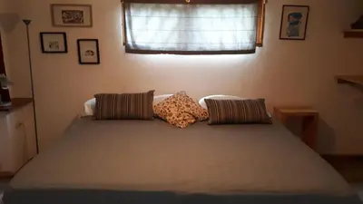 a bed with two pillows on it in a bedroom at Casa SILURI in Santa Teresa Beach