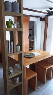 a room with a table and a book shelf at Casa SILURI in Santa Teresa Beach