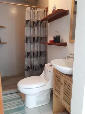 a bathroom with a toilet and a sink at Casa SILURI in Santa Teresa Beach