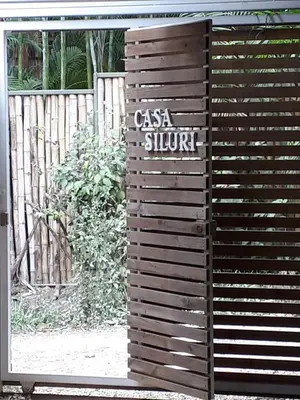 a wooden wall with a sign that reads casa shunt at Casa SILURI in Santa Teresa Beach