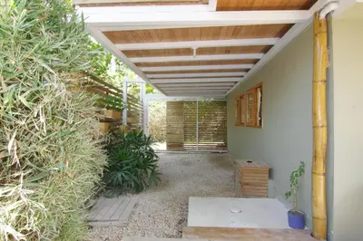 a patio with a wooden pergola at Casa SILURI in Santa Teresa Beach