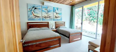 a bedroom with two beds and a window at Hotel Plaza Yara in Manuel Antonio
