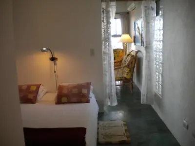 a bedroom with a bed and a room with a window at Plumita Pacifica in Playa Junquillal