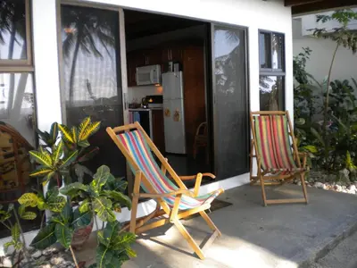 two chairs sitting on the porch of a house at Plumita Pacifica in Playa Junquillal