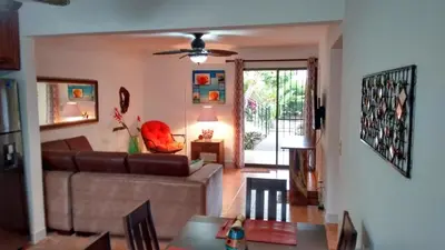 a living room with a couch and a table at Coco Beach Home in Coco