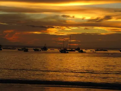 a group of boats in the water at sunset at Coco Beach Home in Coco