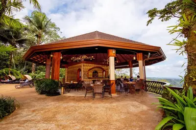 a pavilion with tables and chairs at a resort at The Springs Resort & Spa at Arenal in Fortuna