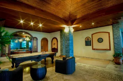 a living room with a pool table in a house at The Springs Resort & Spa at Arenal in Fortuna