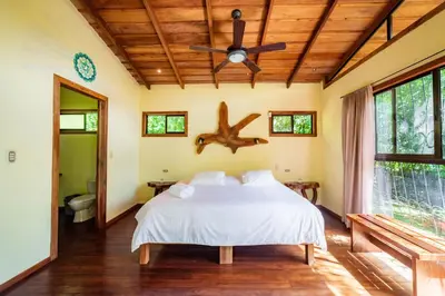 a bedroom with a bed and a ceiling fan at Mystica in Naranjos Agrios