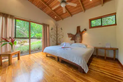 a bedroom with a bed and a large window at Mystica in Naranjos Agrios