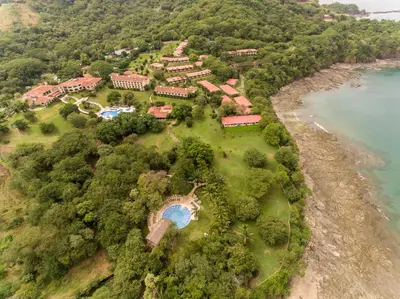 an aerial view of a resort on a hill next to the water at Occidental Papagayo - Adults Only All Inclusive in Papagayo, Guanacaste