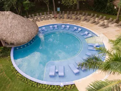 an overhead view of a swimming pool with lounge chairs at Occidental Papagayo - Adults Only All Inclusive in Papagayo, Guanacaste