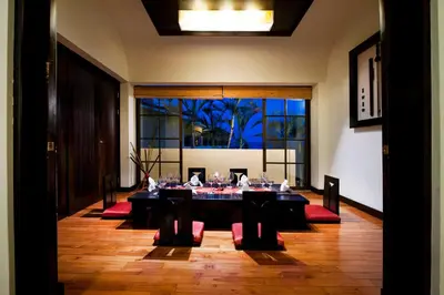 a dining room with a table with wine glasses on it at Occidental Papagayo - Adults Only All Inclusive in Papagayo, Guanacaste