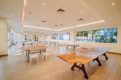a dining room with tables and chairs and windows at Parador Nature Resort and Spa in Manuel Antonio