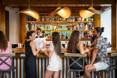 a group of people sitting at a bar at Hacienda Guachipelin Volcano Ranch Hotel & Hot Springs in Liberia