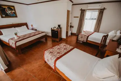 a hotel room with two beds and a window at Hacienda Guachipelin Volcano Ranch Hotel & Hot Springs in Liberia