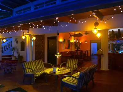 a restaurant with a table and chairs and lights at Cristal Ballena Boutique Hotel & Spa in Uvita