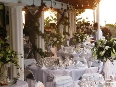 a group of white tables with white chairs and flowers at Cristal Ballena Boutique Hotel & Spa in Uvita