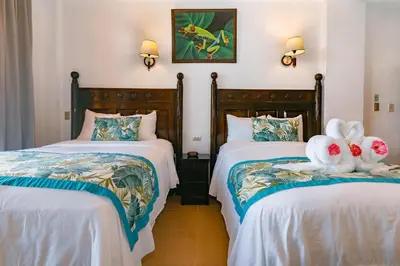 two beds with stuffed animals on them in a room at Hotel San Bada Resort & Spa in Manuel Antonio