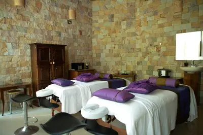 three beds in a room with purple pillows on them at Hotel San Bada Resort & Spa in Manuel Antonio