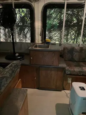 a kitchen in an rv with a sink and windows at Mal Pais Surf Camp in Santa Teresa Beach