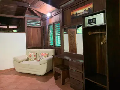 a living room with a chair and a table at Mal Pais Surf Camp in Santa Teresa Beach