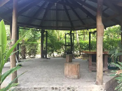 a gazebo with a bench and a table at Mal Pais Surf Camp in Santa Teresa Beach