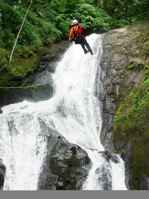 a man is standing on top of a waterfall at Adventure Park & Hotel Vista Golfo in Tajo Alto