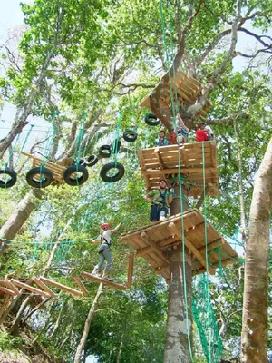 a group of people riding in a tree house at Adventure Park & Hotel Vista Golfo in Tajo Alto
