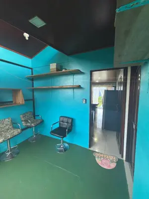 a room with blue walls and two chairs and a mirror at Las Pavitas Arenal Suites in Fortuna