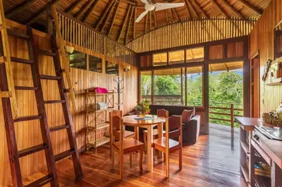 a room with a table and chairs and a ceiling at Junglebungalow in Platanillo
