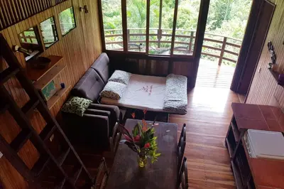 a living room with a couch and a table at Junglebungalow in Platanillo