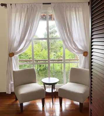 two chairs and a table in front of a window at Tierra Magica B&B and Art Studio in San José