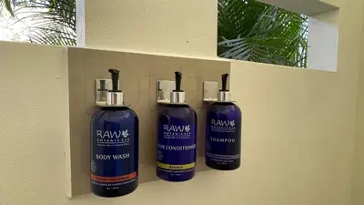 three bottles of shampoo are hanging on a wall at Casitas Sollevante Boutique Hotel in Montezuma
