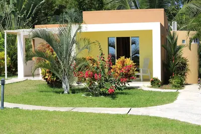 a small house with flowers in front of it at Casitas Sollevante Boutique Hotel in Montezuma