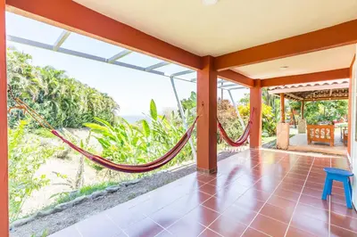 an open porch with a hammock on a house at Casitas Sollevante Boutique Hotel in Montezuma