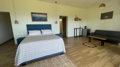 a bedroom with a bed and a couch at Casitas Sollevante Boutique Hotel in Montezuma