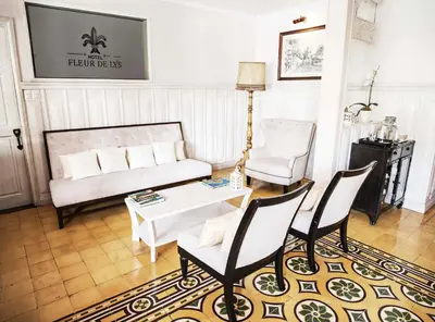 a living room with a couch and chairs and a table at Fleur de Lys in San José