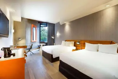 a hotel room with two beds and a desk at Radisson San Jose-Costa Rica in San José