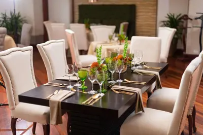 a dining room with a table with wine glasses at Radisson San Jose-Costa Rica in San José