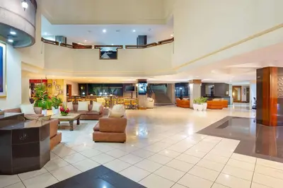 a large room with a lobby with couches and chairs at Radisson San Jose-Costa Rica in San José