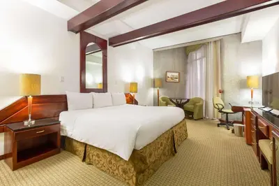 a hotel room with a large bed and a desk at Radisson San Jose-Costa Rica in San José