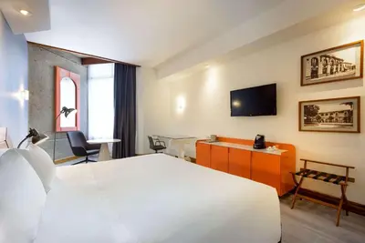 a hotel room with a bed and a flat screen tv at Radisson San Jose-Costa Rica in San José