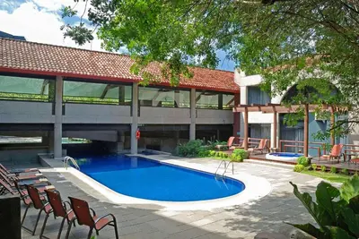 a swimming pool in front of a building at Radisson San Jose-Costa Rica in San José