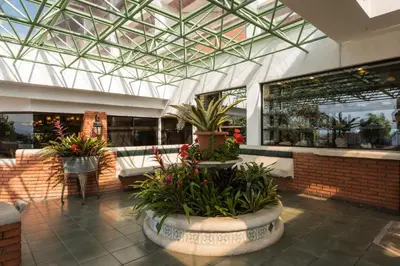 arium of a building with plants in a room at Hotel Bougainvillea San José in Santo Domingo
